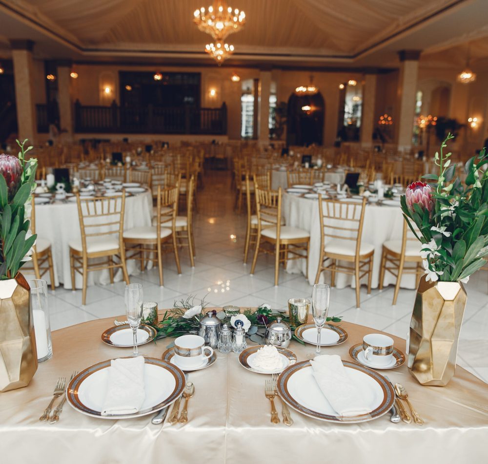 Beautiful wedding decor. Golden dishes in a wedding table